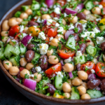 Mediterranean Dense Bean Salad with chickpeas, cucumbers, tomatoes, and feta cheese.
